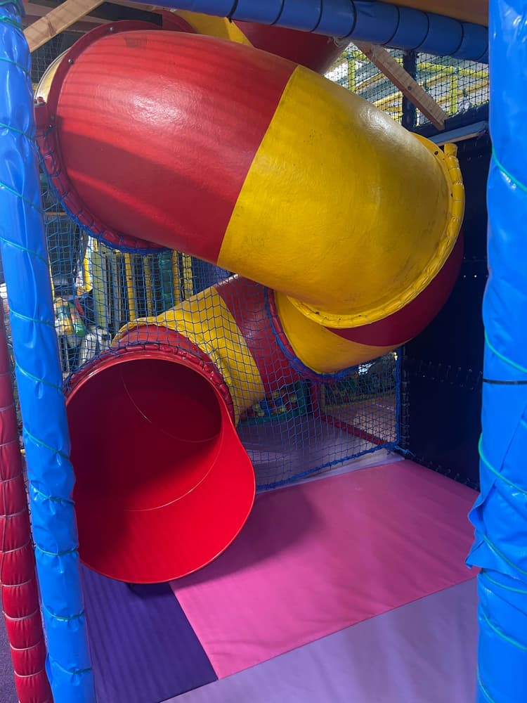 Tube slide inside the soft play frame at Buddies Play Den in Clay Cross.
